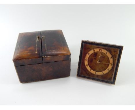 An early 20thC brass and faux tortoiseshell strut bedside clock, of square section, gilt chapter ring bearing Arabic numerals