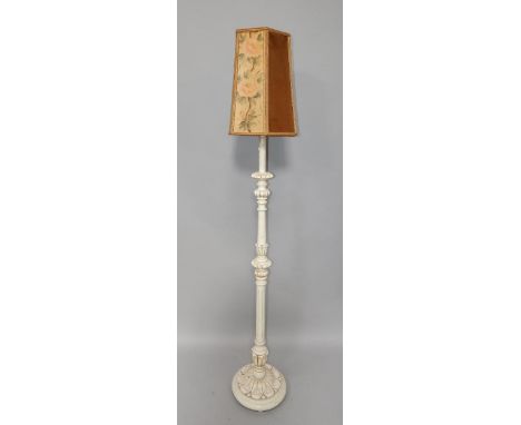 A cream painted French style standard lamp and shade.