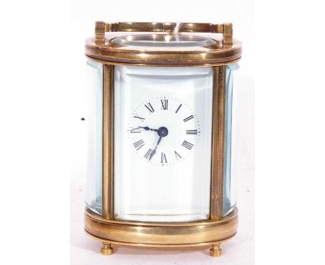 Small carriage clock timepiece with white enamel dial and black Roman numeral hour markers, key wound movement plus key