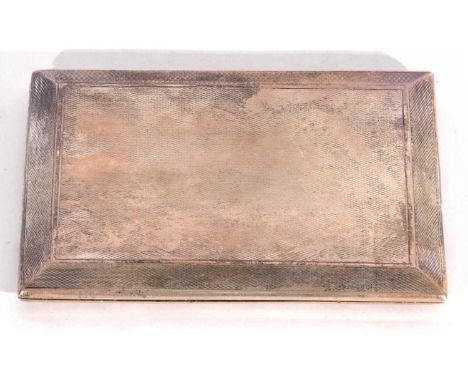 George VI cigarette case of canted rectangular form with all over engine turned decoration, the sliding-opening action reveal