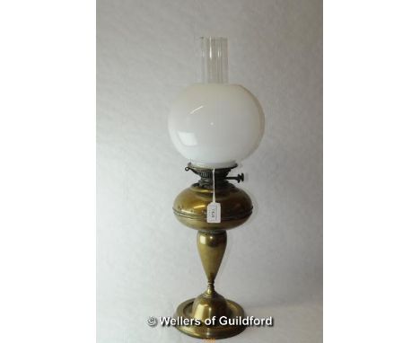 A brass oil lamp milk opaque glass shade, 64cm including chimney.