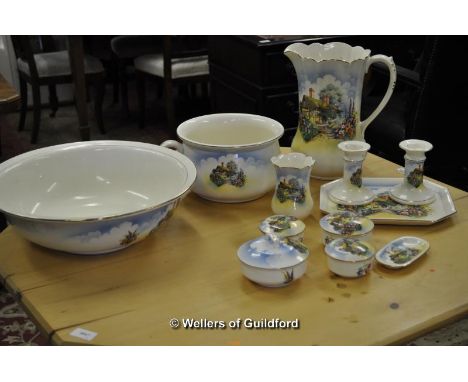 A 1920's jug and basin set comprising jug, basin, tray, pair of candlesticks, toothbrush holder, chamber pot, four lidded pot