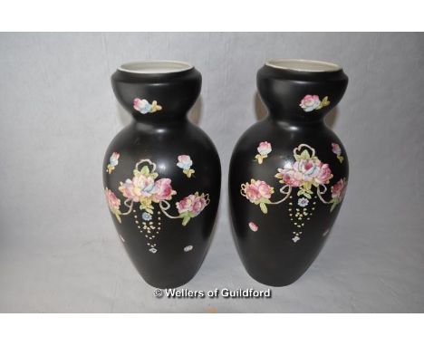 A pair of Crown Devon vases decorated with flowers on black ground, 23cm.