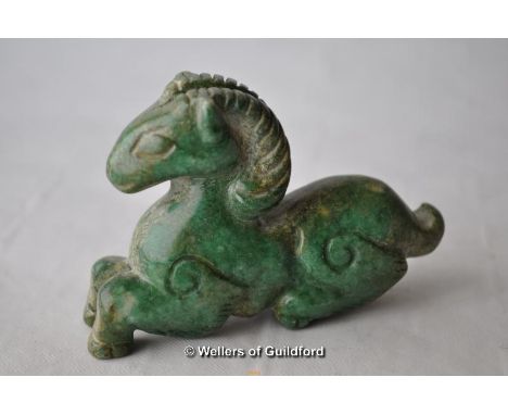 A green jade carving of a recumbent horse, 7cm.