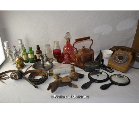 A quantity of bric-a-brac including a copper teapot, pewter candlestick, monkey glove puppet, pair of cranberry glasses, old 