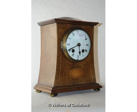 An Edwardian inlaid mahogany mantel clock, the white enamel dial with two train movement, striking on a gong, 26cm.