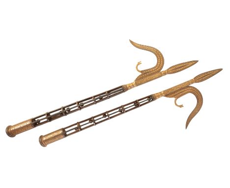 A LATE 19TH CENTURY PAIR OF CEREMONIAL INDIAN METAL AXES the axe heads and grips with floral gilded decoration, 57cm long (2)