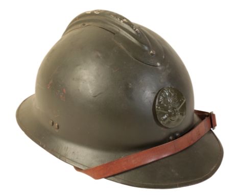 A FRENCH ADRIAN HELMET WITH 'RF' BADGE in green olive paint with 'RF' badge. The helmet post WWI, likely WWII era; the liner 