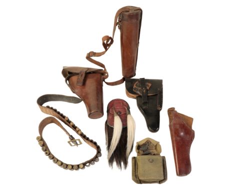 A LATE 19TH CENTURY BROWN LEATHER PISTOL HOLSTER two other pistol holsters; a black leather ammunition belt; a canvas militar