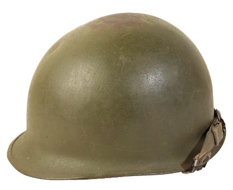 A WWII AMERICAN M1 HELMET with original liner and canvas chin-strap.