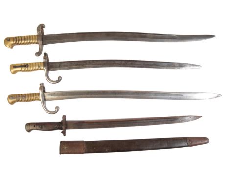 TWO WWI BRITISH BAYONETS with ribbed brass grips; and another British bayonet with wooden grip, in the original leather scabb