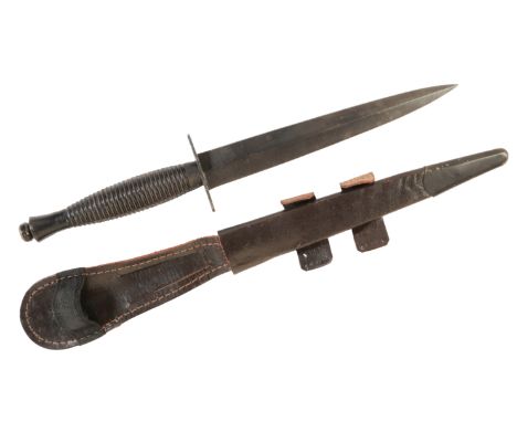 A 3RD PATTERN COMMANDO DAGGER BY ROGERS OF SHEFFIELD made by Rogers of Sheffield, in a black leather scabbard. 1980's example