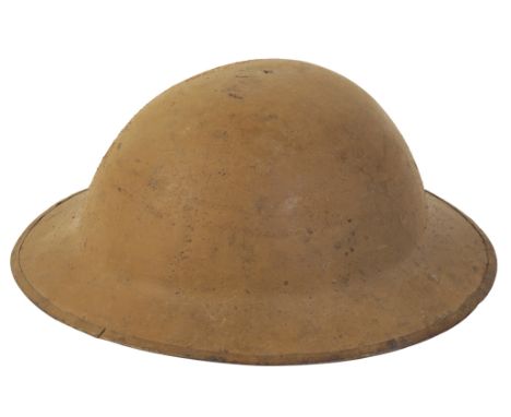 A WWI BRODIE HELMET with a leather chin strap and leather interior, size 7 1/4