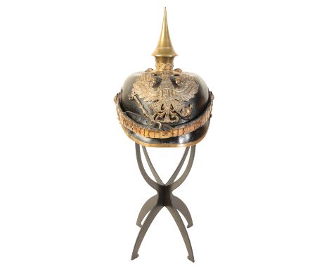 A WWI GERMAN OFFICERS PICKELHAUBE the leather skull with original leather lining, leather and brass chin strap, brass spike t