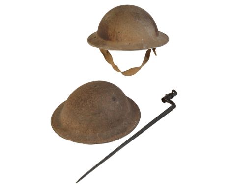 TWO WWII BRITISH ARMY HELMETS with original lining and canvas chin straps; and one spike socket bayonet, stamped no. 6877 (3)