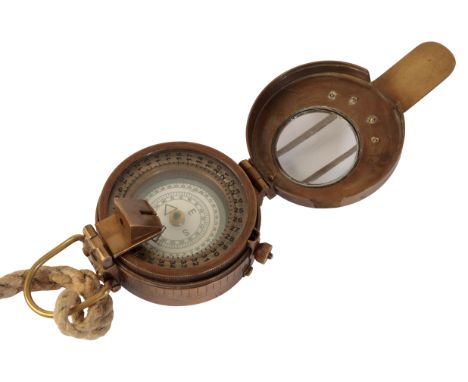A WWII BRASS MILITARY COMPASS stamped to the case back "T.B. Co. Ltd, London", no. 9150296, stamped with military crows foot 