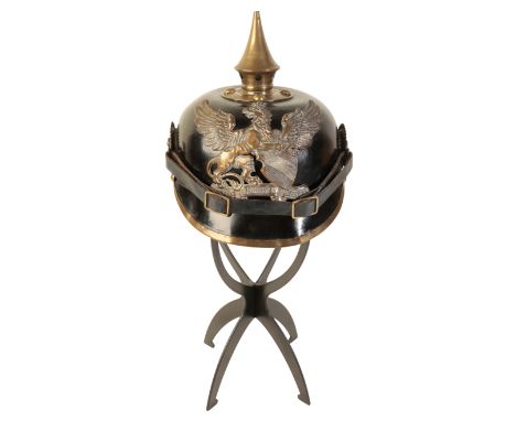 A WWI GERMAN PICKELHAUBE the leather skull with original leather lining and leather chin strap, brass spike and pressed brass