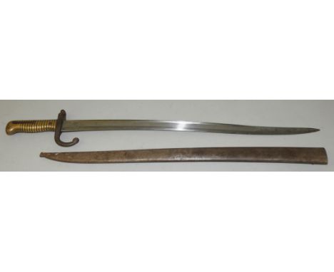 A French Chassepot bayonet, the serpentine fullered blade 57.5cm long marked, St. Etienne Janvier 1875 with brass hilt and cu