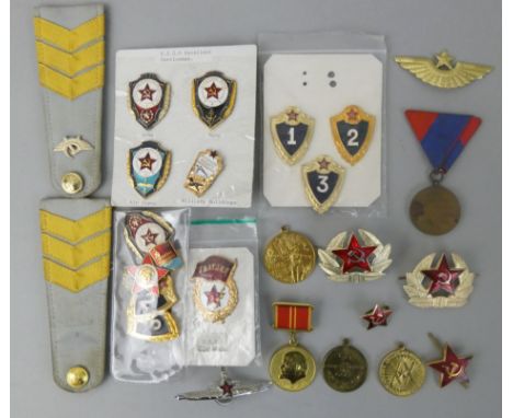 A Soviet era selection of Russian and Iron Curtain of enamelled army, navy and air force badges, together with medals commemo
