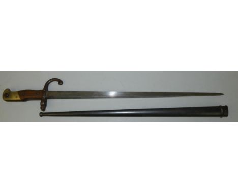 A French Gras bayonet having a 52.5cm straight broad spined blade marked 1880, and having a curved quillion, the hilt with a 