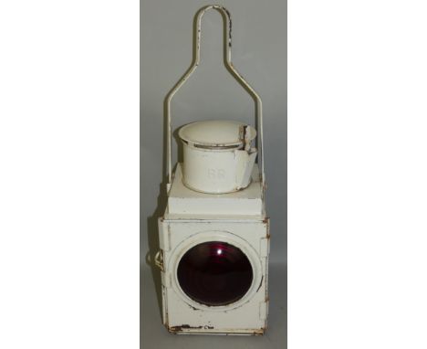 A British Rail white enamel paraffin lantern, with red bullseye lens, height 52cm.