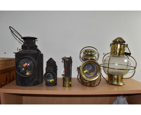 A GROUP OF LAMPS, comprising a Midland Railway Co lamp, height approximately 33cm excluding handle, a brass Davy lamp, a Hiat