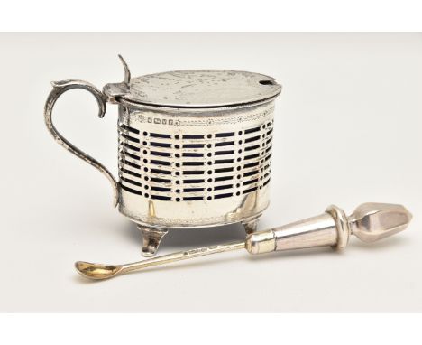 A LATE VICTORIAN SILVER MUSTARD WITH SAUCE SPOON, the mustard of an oval pierced form, raised on four feet with scroll handle