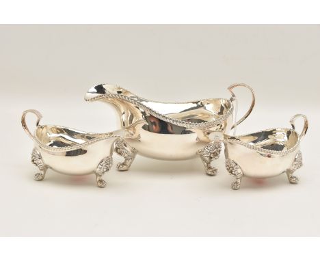 THREE SILVER SAUCE BOATS, a larger sauce boat, two smaller sauce boats, each raised with three lions head feet, hallmarked 'D