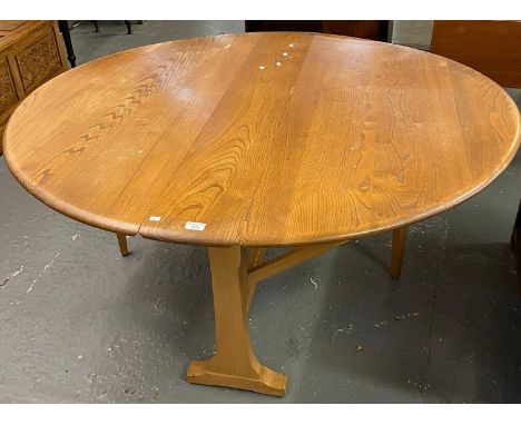 Mid century Ercol Elm Windsor drop leaf table. 142cm diameter x 72cm high approx. (B.P. 21% + VAT) 