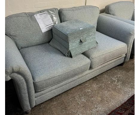 Modern mint green upholstered two seater sofa and matching armchair. Purchased at DFS. Together with a matching stool. (3)   