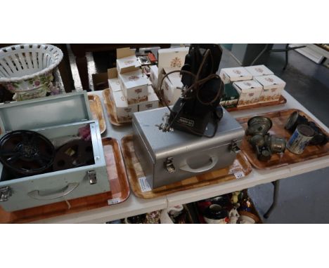 Two tin boxes comprising cine film projector with various reels including: 'Micky Mouse' together with two vintage carbide li