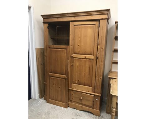 A modern pine wardrobe with two cupboard doors over two drawers on bracket feet 138 cm wide x 56.5 cm deep x 206 cm high and 