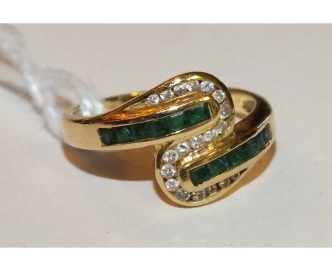 An 18ct yellow gold ring set twelve square cut emeralds and nineteen diamond points, size K½, 3.6g.