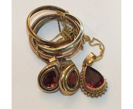 A 9ct gold pendant set pendeloque cut garnet, a pair of similar ear studs and a 9ct gold Russian wedding ring, size K, total 