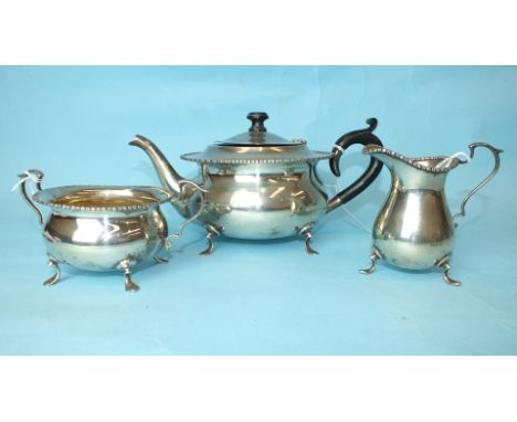 A silver three-piece tea service by C S Green & Co, each piece of bellied form standing on trefoil feet, Birmingham 1923, gro