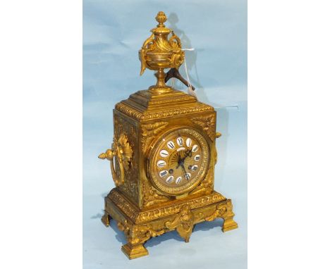 A late-Victorian gilt metal mantle clock, the square case with urn finial, gilt dial and enamelled numerals, signed 'Richard,