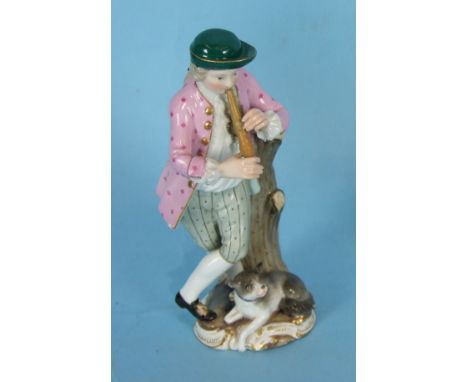 A 19th century Meissen porcelain figure of a standing shepherd playing a flute, with a dog at his feet, some damage, crossed 