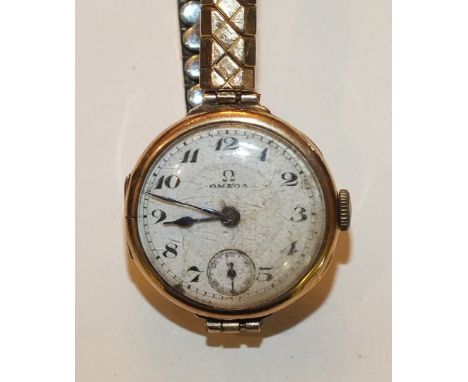 Omega, a ladies 9ct-gold-cased wrist watch c1920's, the white enamel dial with Arabic numerals and seconds subsidiary, on pla