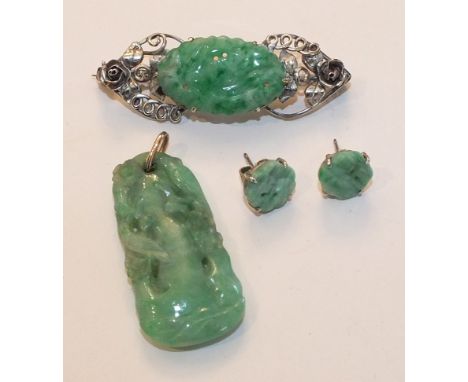 A Chinese jade pendant carved in the form of a tree with birds amongst the foliage with yellow metal bale, a carved jade broo
