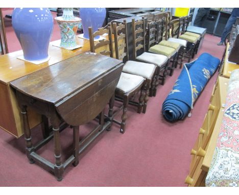 A Late XIX Century/Early XX Century Oak Gateleg Table, (top split), together with a group of eight ladder back dining chairs.