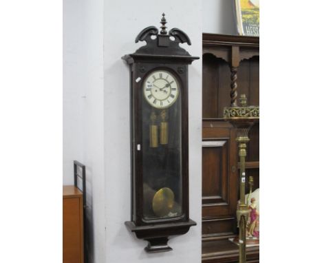 A Mahogany Vienna Wall Clock, turned finial, Roman numeral dial, full length, glass front.