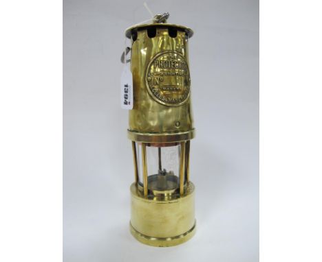 Miners Lamp, The Protector of Eccles, in brass 22.5cm high with handle down.