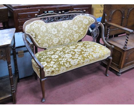 A Late XIX Century Mahogany Salon Sofa, the back with carved pierced fret work, faded gold upholstery.