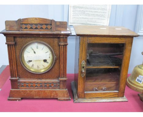 Early to Mid XX Century Oak Smokers Cabinet, 29cm high; an early XX Century eight-day oak mantle clock, cross arrow to dial w