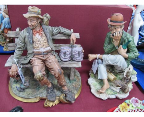 Capodimonte Figure of a Tramp on a Bench, signed Volta, another of a tramp playing mouth organ by S Maggioni.
