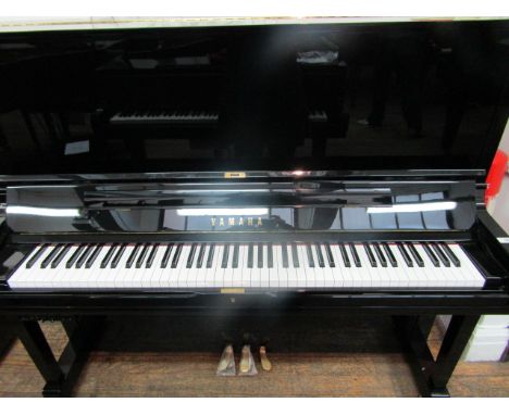 Yamaha (c2012)  A Model YUS3 upright piano in a bright ebonised case, fitted with a silent system; together with a stool.