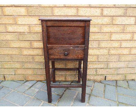 A compact hinge-lidded cabinet with single drawer below