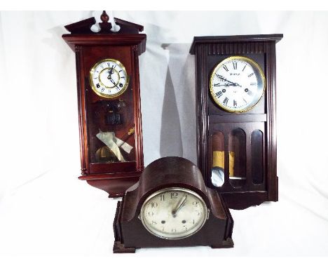 Three clocks comprising two wall clocks, the dials scribed 'Highlands' and 'Vintage, both with pendulums and keys, and an oak