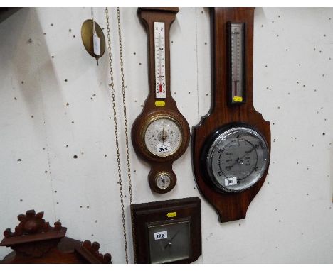Two aneroid barometers with integral thermometers and one further oak  framed barometer (3)