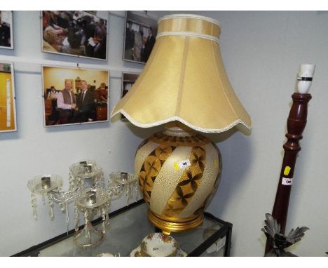 A large table lamp (gold colour and cream) and a candelabra (2)